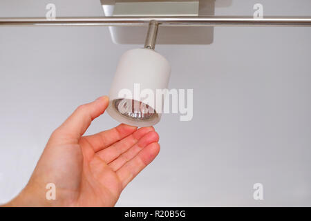 Electrical engineers are installing ceiling lamps in the hallway. Stock Photo