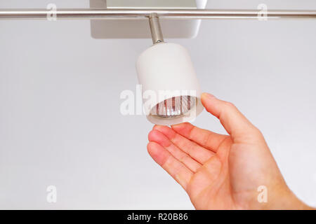 Electrical engineers are installing ceiling lamps in the hallway. Stock Photo