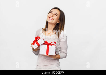 Beautiful woman holding a gift boxes with red ribbon. Isolated on white background Stock Photo