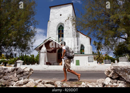 School kid walking by a church in Avarua, Rarotonga, Cook Islands. Stock Photo