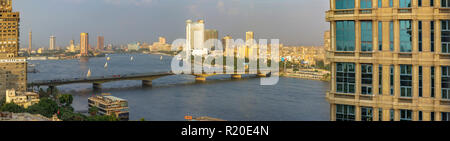 Cairo University Bridge over the River Nile from Giza to Cairo, Egypt, views of downtown skyscrapers and Hyatt Grand Nile Tower revolving restaurant Stock Photo