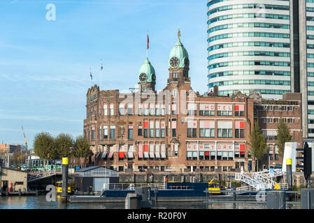 Rotterdam,Holland,14-nov-2018:Hotel New York based in the former Holland America Line Office building on the Kop van Zuid in Rotterdam, the Netherlands. The World Port Center on the right Stock Photo