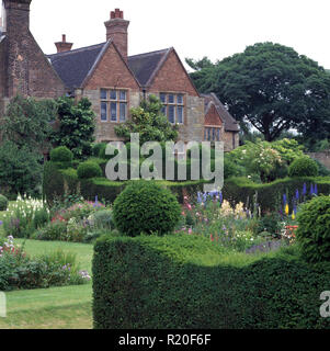 Clipped hedges and topiary in large country garden Stock Photo