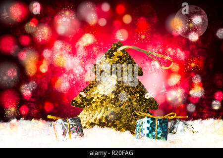 Christmas treee made with golden paillettes and some decorative gift holiday composition, beautiful background to add text. Stock Photo