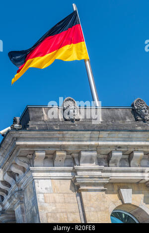 The German National Flag flies above the Reichstag in Berlin, Germany. Stock Photo
