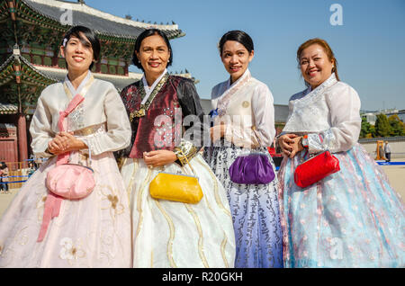 Group of friends pose for a picture at Gyeongbokgung Palace in Seoul, dressed in traditional Korean dress, the hanbok. Stock Photo