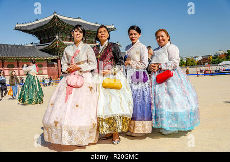 Group of friends pose for a picture at Gyeongbokgung Palace in Seoul, dressed in traditional Korean dress, the hanbok. Stock Photo