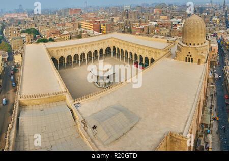 Explore medieval Sultan Al-Mu'ayyad mosque from the tower of Bab Zuwayla Gate, that opens the view on the zigzag shaped dome, foursquare roof and ablu Stock Photo