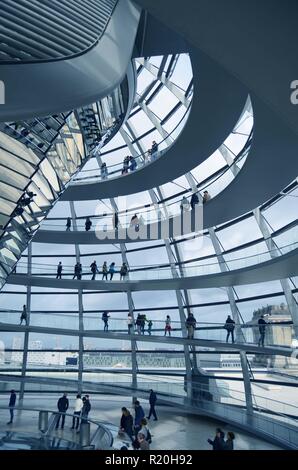 View of tourists on the walkway inside the glass dome on the roof of the Reichstag building, Berlin, Germany Stock Photo