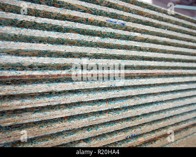 Side surface of a stack of sheets of laminated tongue-and-groove chipboard Stock Photo