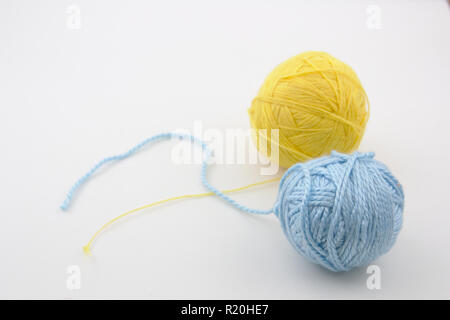 Two balls of wool to weave on white background with space for some text (copy space) on a white table Stock Photo
