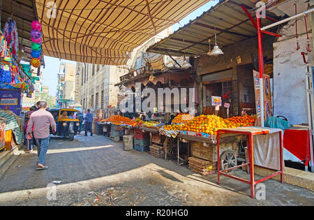 CAIRO, EGYPT - DECEMBER 21, 2017: The line of fruit stalls with heaps of fresh oranges in covered section of Al Khayama street market, on December 21  Stock Photo