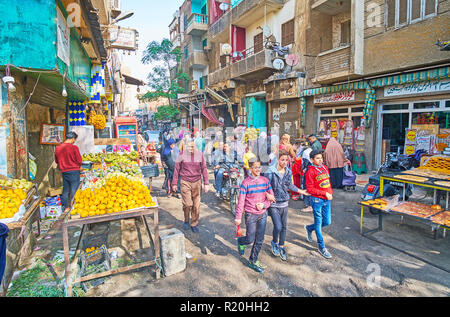 CAIRO, EGYPT - DECEMBER 21, 2017: The crowd of people in food market of Al Khayama street with fruit stalls and a bakery, on December 21 in Cairo. Stock Photo
