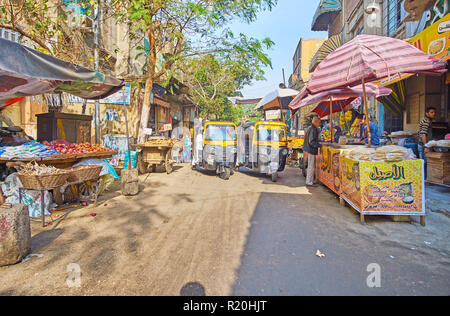 CAIRO, EGYPT - DECEMBER 21, 2017: Tuk-tuks are popular in old town, they can drive even in narrow streets with obstacles, such as Al Khayama street, o Stock Photo