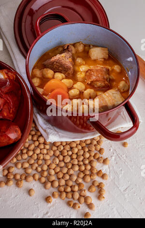 Homemade chickpea stew Madrid stew of chickpeas, meat and vegetables (chorizo, blood sausage, ham, garlic, onion, carrot, veal, chicken). Typical Span Stock Photo