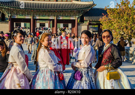 Group of friends pose for a picture at Gyeongbokgung Palace in Seoul, dressed in traditional Korean dress, the hanbok. Stock Photo