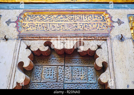 CAIRO, EGYPT - DECEMBER 21, 2017: Details of the minbar in Sultan Hassan Mosque-Madrasa, golden inscription from Quran, stone carvings and amazing woo Stock Photo