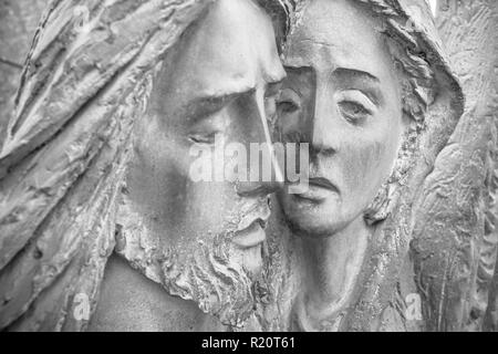 Bas-relief in bronze representing The Pity of Michelangelo. Faces of Holy Mary mother and Jesus Christ after the Crucifixion. Stock Photo
