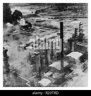 Photograph of Oil storage tanks at the Columbia Aquila Refinery burning after the air raid of B-24 Liberator bombers of the United States Army Air Force. Dated 1943 Stock Photo