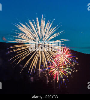 Three fireworks over blue sky background Stock Photo