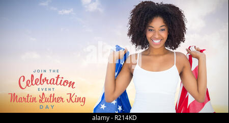 Composite image of pretty girl in white top holding american flag Stock Photo