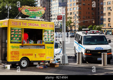 New York City, USA - June 29, 2018: Nathan's Hot Dog Food Truck and NYPD vehicle parked at the Columbus Circle. Stock Photo