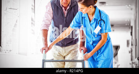 Nurse helping senior man with walking aid Stock Photo