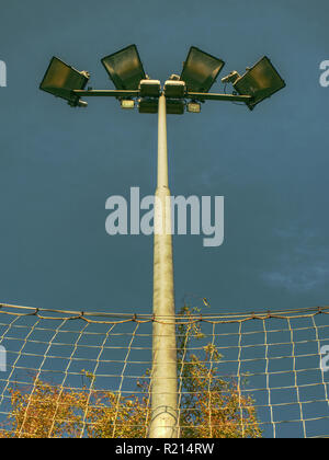 Lonely stadium light or lamp post with Union of light bulb stand alone with clould and blue sky. Stock Photo