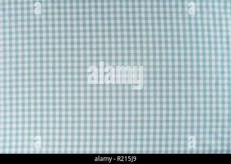 Mint and white is the checkered pattern on a tablecloth. The fabric is woven and is wrinkle free. Stock Photo