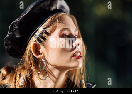 Fashionable model wearing leather beret participating in photo session Stock Photo