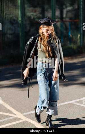 Appealing fashion model enjoying the sunshine while posing outside Stock Photo