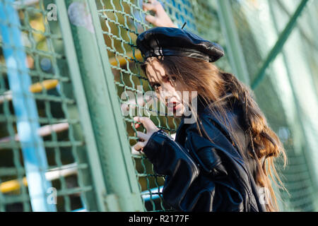 Beautiful young model posing for photographer with bright red lips Stock Photo