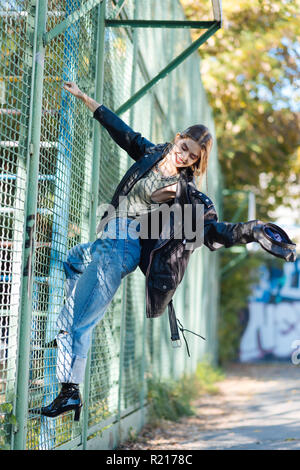 Trendy skinny model at the stadium while posing for photographer Stock Photo