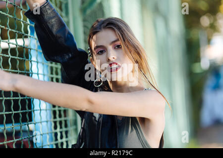 Fashionable trendy model wearing khaki shirt and leather jacket Stock Photo