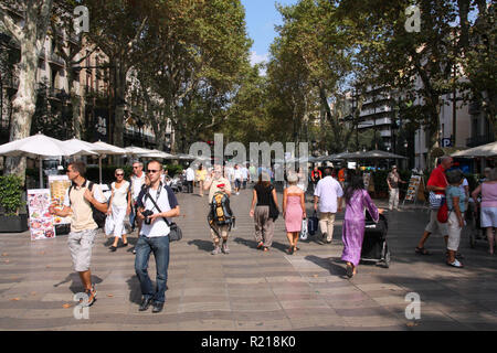 BARCELONA, SPAIN - SEPTEMBER 13: Tourists strolling famous Ramblas on September 13, 2009 in Barcelona, Spain. Rambla boulevard is one of the most reco Stock Photo