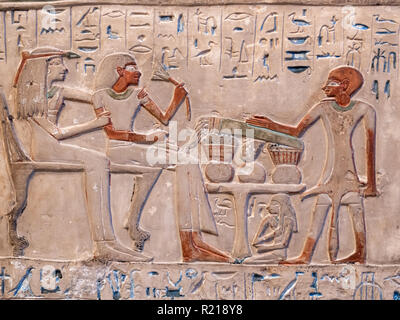 Closeup of egyptian hieroglyphs and paintings on an ancient stone Stock Photo