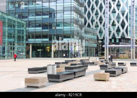 MANCHESTER, UK - APRIL 22, 2013: People visit MediaCityUK in Manchester, UK. MediaCityUK is a 200-acre development completed in 2011, used by BBC, ITV Stock Photo