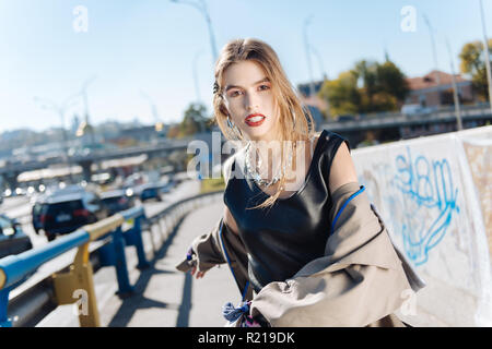 Fashion blogger with bright red lips wearing massive silver necklace Stock Photo