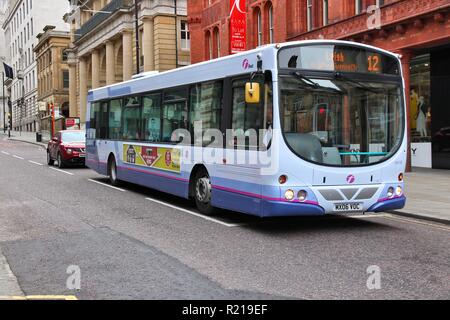MANCHESTER, UK - APRIL 21, 2013: People ride FirstGroup city bus Volvo B7RLE in Manchester, UK. FirstGroup employs 124,000 people. Stock Photo