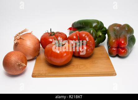 Vegetables (tomatoes, peppers, onions) on the wooden board Stock Photo