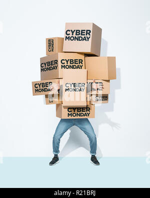 The lot of gift boxes in the hands of young man on white studio background. Cyber monday, shopping, holiday, happy Christmas, sales season start concept Stock Photo