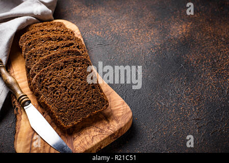 Fresh sliced rye bread on rusty background Stock Photo