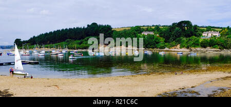 St Just in Roseland, UK - 25th July 2017: A calm summer morning brings people out to their small boats on the creek at St Just in Roseland on the picturesque Roseland Peninsula in Cornwall, UK Stock Photo