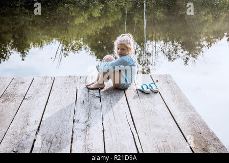 Lonely small girl dreaming Stock Photo