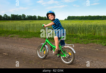 boy on bicycle in rural landscape Stock Photo