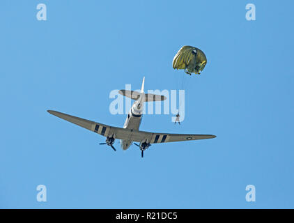 MONROE, NC (USA) - November 10, 2018: An army paratrooper jumps from a C-47 cargo aircraft during a demonstration at the Warbirds Over Monroe Air Show Stock Photo