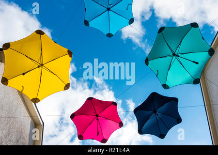 A display of coloured umbrellas above an outdoor shopping mall in Kendal, Cumbria, the Lake District, UK Stock Photo