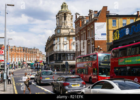 View of St. John's Hill with vehicles, buildings and people on a sunny Summer day, Clapham Junction , Wandsworth, London, UK Stock Photo