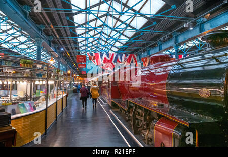 Steam train and cafes in the Station Hall, National Railway Museum, York, North Yorkshire, England UK Stock Photo