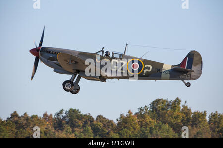 MONROE, NC (USA) - November 10, 2018: A British Spitfire fighter aircraft rises above trees during the Warbirds Over Monroe Air Show. Stock Photo